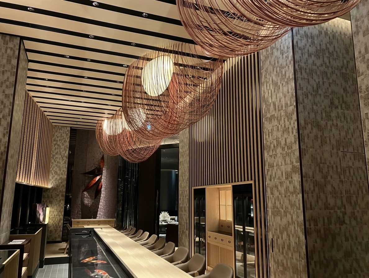 Hotel corridor with sculptural spiral copper wire pendant lighting