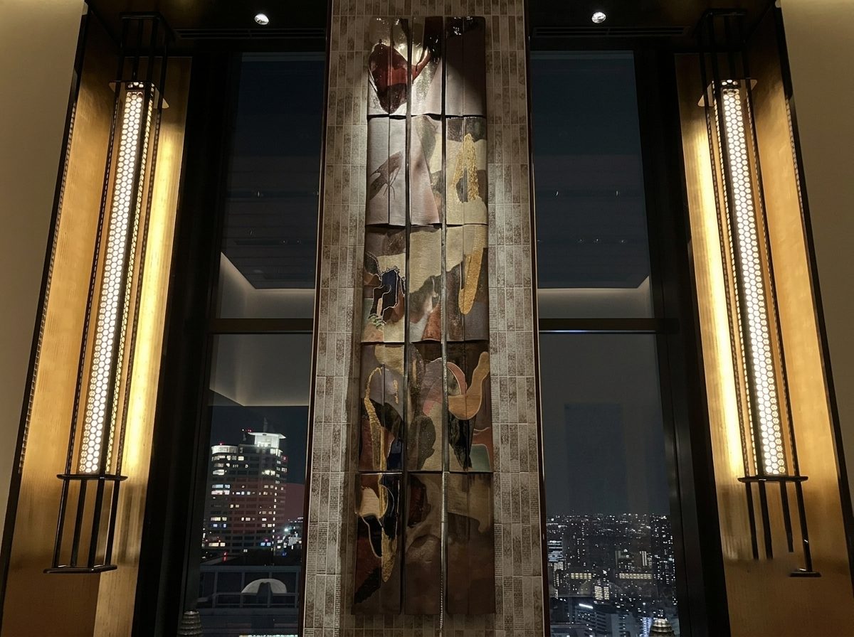 Illuminated art wall panel flanked by vertical LED wall sconces